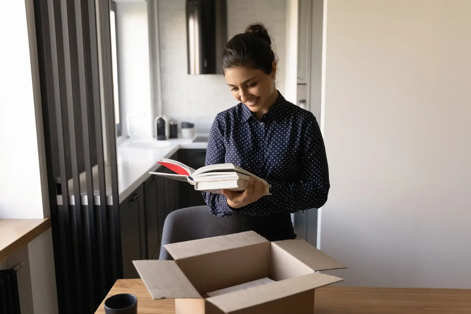 Woman smiling while reading a newly published book